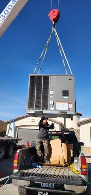 Installation of 5 ton package unit at a home using crane.