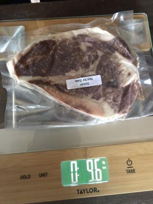 Actual packaging and weight of a cut of meat. The 0 is pounds and the right side number is ounces. A pound is 16 ounces.