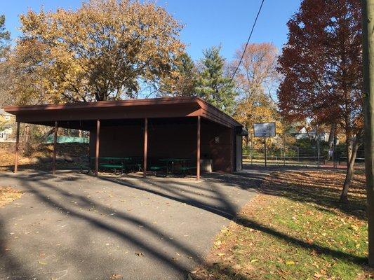 Covered picnic tables, basketball hoop, and tennis courts.