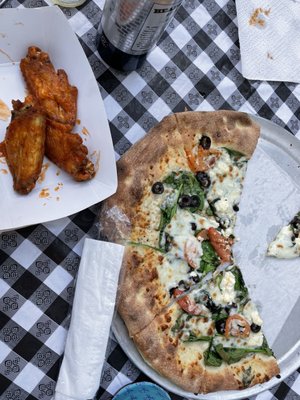 White garlic pizza with spinach, feta, tomato