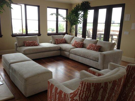 Customized sectional with ottoman and arm chairs.