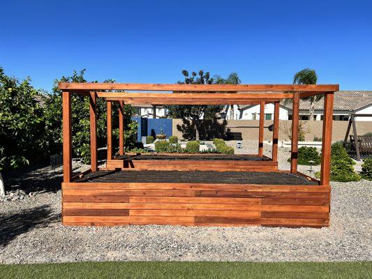 Two large 4x12 redwood garden boxes with stain and shade posts.