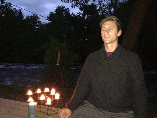 Guest Instructor, Luke Ketterhagen. Leading a moonlight meditation on the yoga deck near the river.