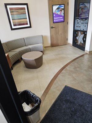 The waiting area with a sofa and coffee table creates a familiar home environment.