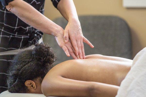 Instructor Carol Young teaches the students how to correct do a back massage.