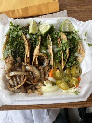 Tacos - Pork, 2 chicken and an asada. Lots of cilantro, grilled onions and jalapeños . Don't forget to ask for the creamy green hot sauce.