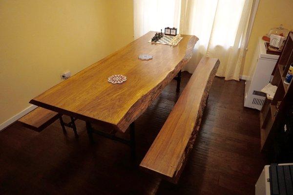 8' live edge locally salvaged pecan dinning room table with twin benches and modern industrial legs. Comfortably seats 12.