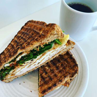 Roasted veggies, mozzarella and pesto sauce in a multigrain toast