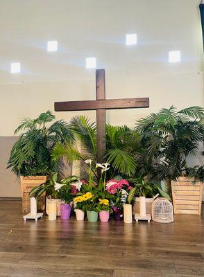 Beautiful Easter flowers around the cross for Easter Service.