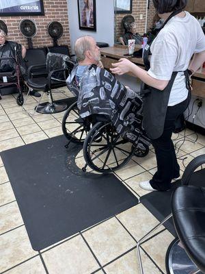 My spouse getting hair cut and beard trim.