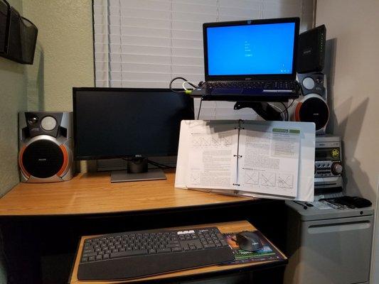 Raising the laptop creates space for my desk easel, making reading and typing more ergonomic.