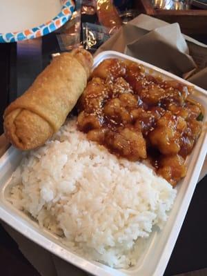 Sesame Chicken combo with white rice and an egg roll.