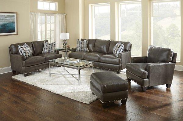 The Patrese living room group is covered in a beautiful 100% charcoal grey leather. Set includes sofa, loveseat, chair and ottoman.