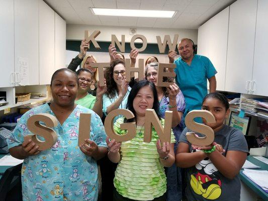 The staff bringing attention to Ovarian Cancer Awareness month.