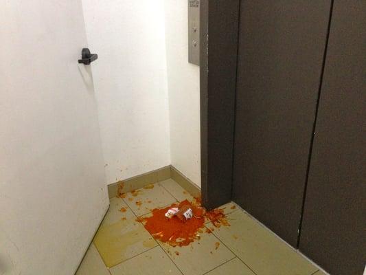 Spilled food in front of the elevator.