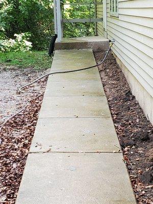 A badly settled sidewalk that is now raised, and the step height is now a safe 7" normal step.