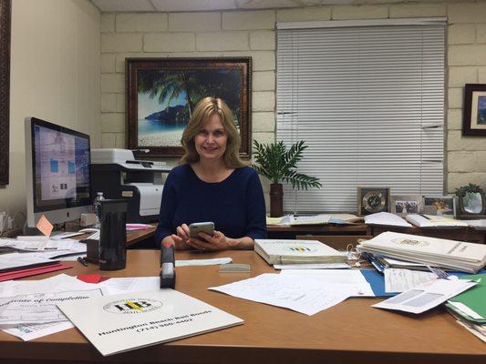 Huntington Beach Bail Bonds owner Bonnie Merrick hard at work helping out her clients.