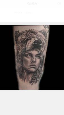 Black and gray Berserker woman done the outer thigh.