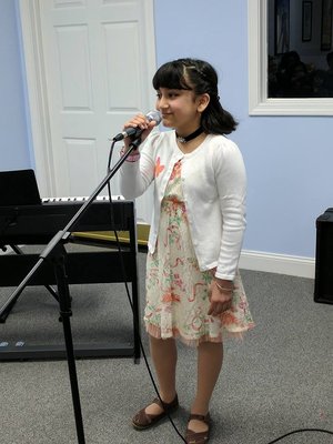 Student singing for performance