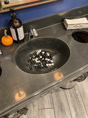 Bathroom sinks, with stones.