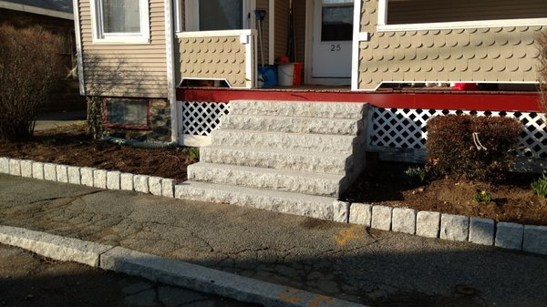 Granite steps and cobblestone wall.