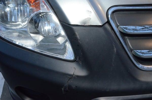 Here is a before picture of the damage on the bumper and a portion of the hood of my Honda CR-V, taken after the accident.