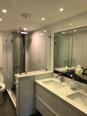 Bathroom 90° frameless shower door and bathroom vanity mirror