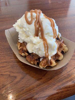 Vanilla ice cream with caramel drizzle on a homemade waffle