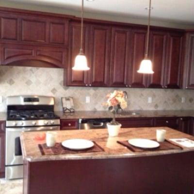 Another satisfied Customer rosewood granite countertops and island with roman ogee edge