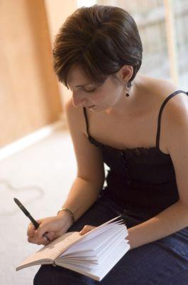 Founder, Marilyn Friedman writing in class