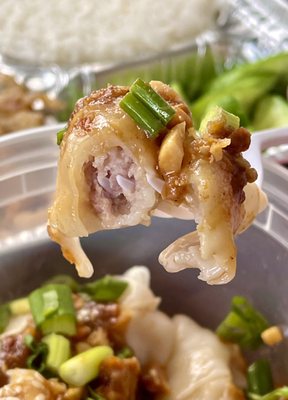 7 flavor wonton with peanut sauce showing the pork filling