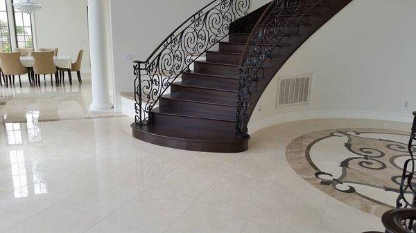 Stairway by ETC, as well as marble floor and tile medallion.