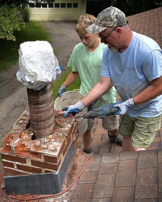 Sid (owner) teaching repairs to his grandson Troy during a repair job.