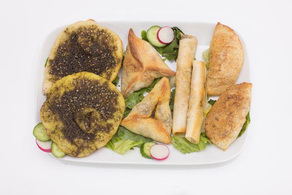 Variety of pastries: zaatar manoushe, spinach pastry , beef and chicken rolls , beef and chicken pastry