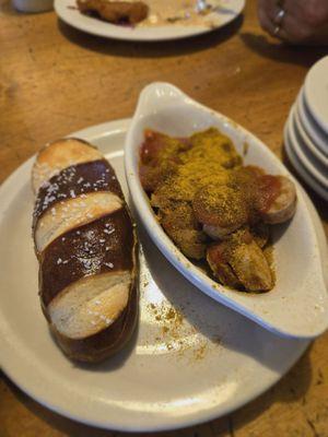 Curry brat with pretzel roll