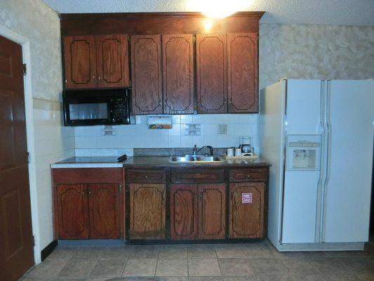 Full sized granite countertop kitchen with stove, microwave, sink, refrigerator, and coffee maker. We also include pots and pans + utensils!