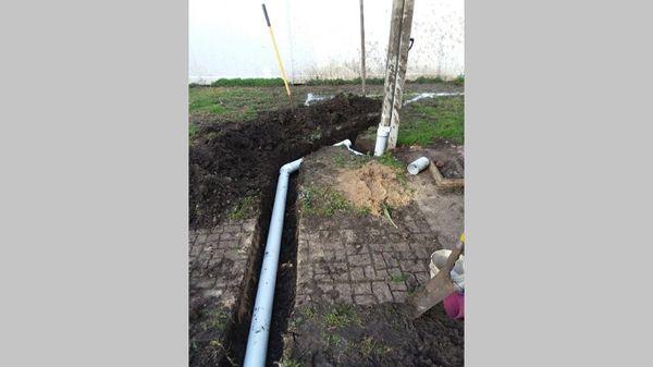 Connecting area drains and downspout drains to a 4" inch drain line that will divert rainwater runoff to the curb.