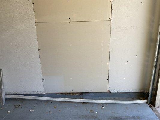 Repaired section of the wall in the car garage linked to a leak from the roof was not mentioned in the inspection.