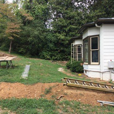 Before picture of back yard makeover including irrigation seed, deck installation and patio installation