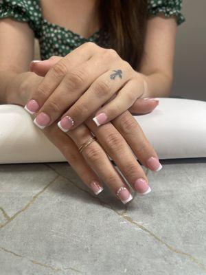 Short French tip with diamonds on ring finger