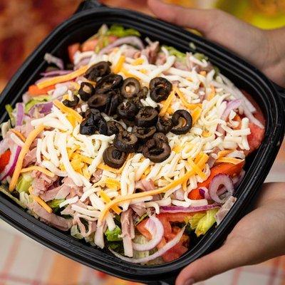 Our Antipasto salad includes ham, salami, mozzarella cheese, tomatoes, red onions, black olives & pepperoncini peppers.