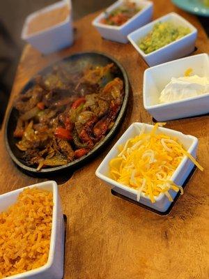 Steak Fajitas come piled high on a sizzling platter with more than my husband could eat!