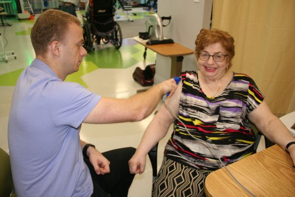 Our awesome Occupational Therapist with a very happy patient!