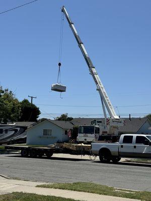 Crane lifting the jacuzzi over my house