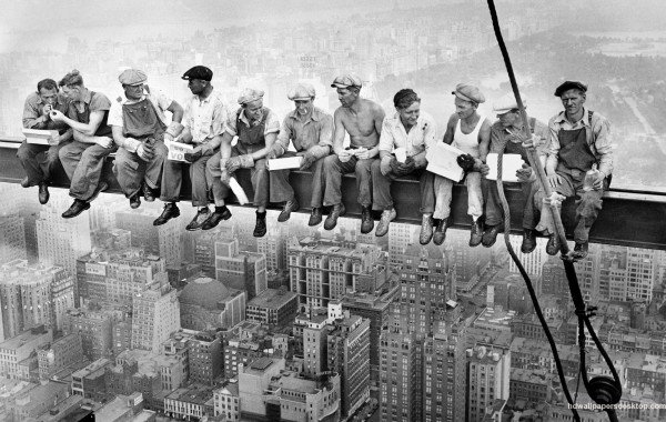 Steel workers take time out for lunch, 800ft above the street, before resuming work on the R.K.O Building.