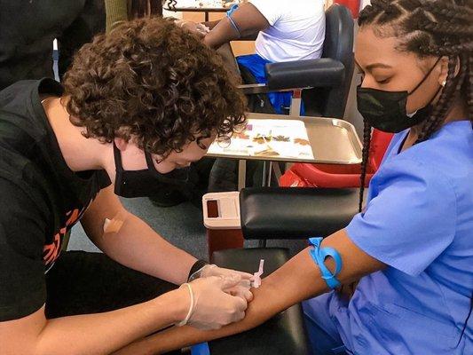 Students of medical clinic and patient care technician practicing with their classmates