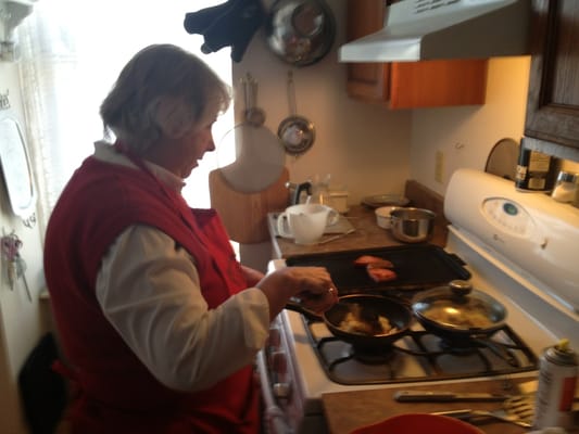 Tina cooking breakfast for guest!