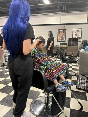 He got a student with beautiful blue hair to cut his hair