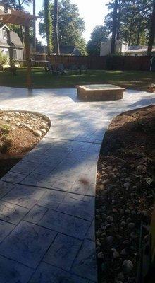 Ashler slate stamped walkway and patio with  stone firepit