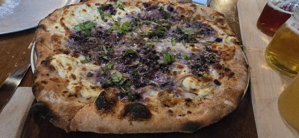 Veggie Soecial - lemon thyme ricotta, blueberries, shallots, mozzarella, parmesan, herbs, topped with fresh basil